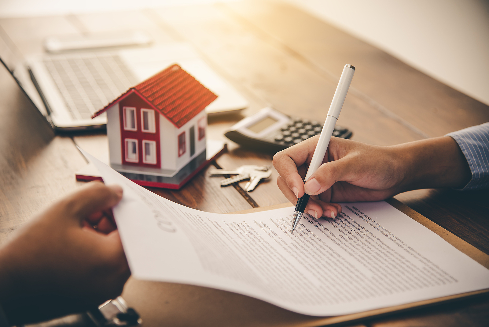 House signers signing signature loan document to home ownership with real estate agents ownership. Mortgage and real estate property investment, home insurance